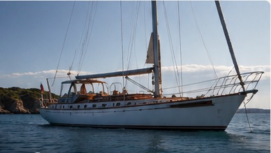 Classic white monohull sailing yacht on open water
